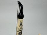a black and white pipe with a chain attached to it