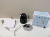 a black and white coffee maker and a notepad on a white table