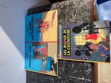 three books that are on the wall of a room