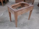 a small wooden table with a glass top on it
