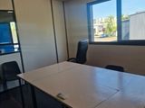a table and chairs in a room with a large window
