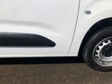 a small white van parked on the side of the road