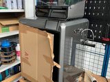 a microwave sitting on top of a wooden table in a room
