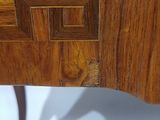 a wooden table with a cross design on the top of it