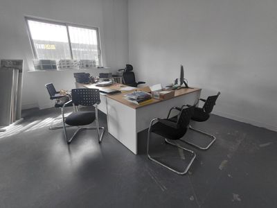 an image of an empty office with a desk and chairs