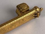 a gold lighter that is sitting on a table