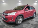 the red suv is parked in the garage on a checkered floor