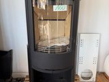 a black stove sitting on a pallet in a room