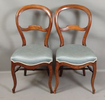 pair of antique walnut chairs with blue upholstered cushions