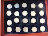a display case with a lot of silver coins in it