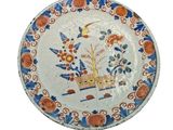 a plate with a picture of a boat and flowers on it