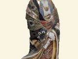 a figurine of a woman in a kimono dress