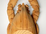 wooden sculpture of a lobster hanging on a wall
