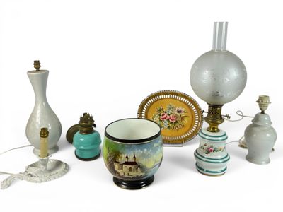a lot of different vases and lamps on the table