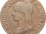 a close up of a coin with a woman ' s head on it