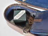 a suitcase with a tie and a key inside of it