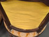 pair of antique chairs with yellow cushions in the shape of a chair