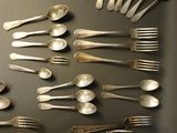 a lot of silver spoons and spoon spoons on a table