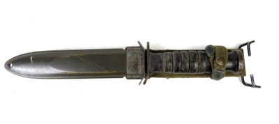 a knife that is laying on top of a white surface
