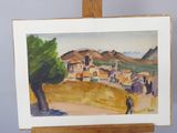a painting on a easel with a painting of a village in the background