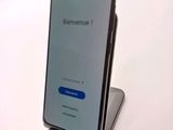 the back of a phone with a blue screen sitting on top of a table