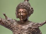 bronze statue of a woman holding a sword in her right hand