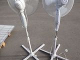 two white fans that are on the ground next to each other