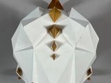 an origami paper sculpture of a pyramid with gold pyramids on top