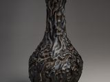 a black vase that is sitting on a table