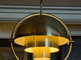 the light fixture is hanging from the ceiling in the dining room