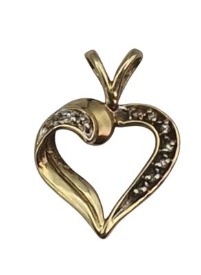 a close up of a heart shaped pendant on a white background