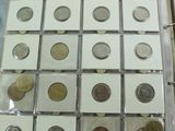 a lot of coins in a binder on a table