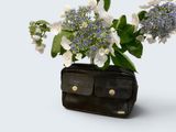 a black purse with a bunch of flowers in it