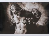 black and white photograph of a naked woman with hands on her chest