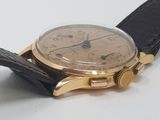 a close up of a watch on a white surface
