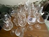many empty wine glasses sitting on a wooden table