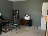 a room that has a desk and a chair in it