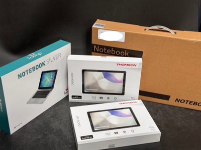 three boxes of notebooks sitting on a table next to each other