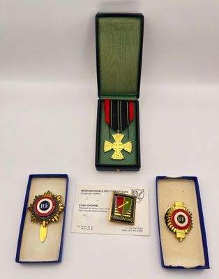 three medals are in a box on a white surface