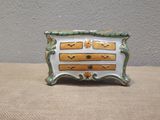 a picture of a ceramic dresser with drawers on it