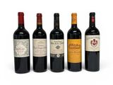 four bottles of wine are lined up on a white surface