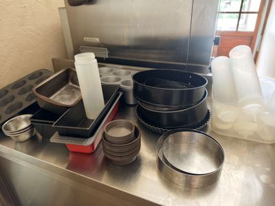a kitchen counter with a lot of pots and pans on it