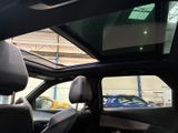 a view of a car ' s sunroof from inside the vehicle