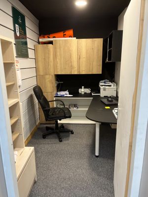 a small office with a desk and a chair in it