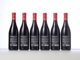 six bottles of red wine lined up in a row