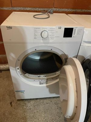 a washer and dryer sitting next to each other on the floor