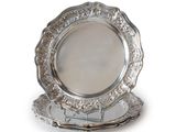 a silver plate on a stand on a white background