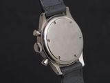 a close up of a watch on a black background