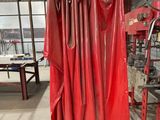 a rack of red leathers hanging from a ceiling