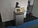 a microwave on top of a small refrigerator in a kitchen